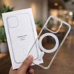 May include: Clear iPhone 13 Pro case with a magnetic ring and a matching box. The box reads "For iPhone 13 Pro Clear Case Magnetic". The case is transparent, allowing the phone's design to show through. The case is designed to protect the phone.
