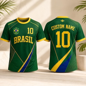 May include: A green short-sleeve jersey with yellow trim, featuring the text BRASIL and the number 10 on the front, and CUSTOM NAME with the number 10 on the back. The design includes a Brazil flag emblem and blue and yellow diagonal accents.