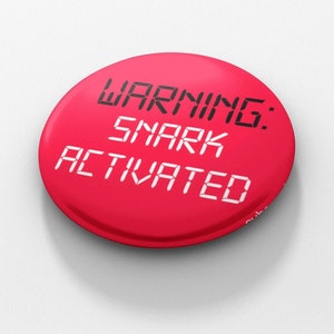 May include: A red button with the text "WARNING: SNARK ACTIVATED" in a digital font.