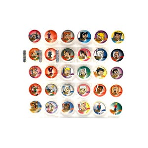 May include: A collection of Archie Comics character collectible buttons. Each button features a different character portrait in a circular design. The buttons are arranged in rows and columns, with a few small, rectangular stickers included.