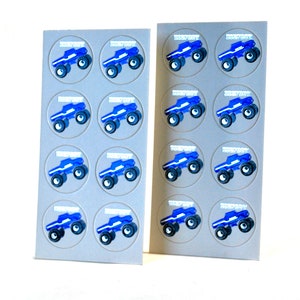 May include: Two sheets of stickers featuring a blue monster truck design. Each truck is in a gray circle with the word "BIGFOOT" above it. The trucks have black tires and white accents. The stickers are on a white background.
