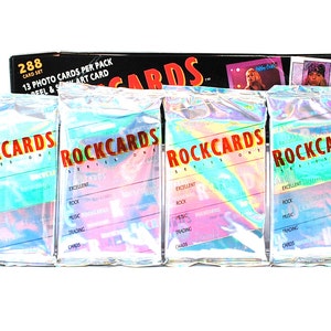 May include: Four sealed packs of Rockcards Series One trading cards. Each pack features a holographic design with the text "Rockcards Series One" in red and white.