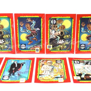 May include: A set of nine trading cards featuring illustrations of classic horror movie monsters. The cards are red with a green border and feature a yellow moon in the background. The monsters include Frankenstein's monster, Dracula, the Creature from the Black Lagoon, and the Wolfman.