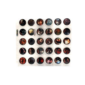 May include: A collection of 30 round collectible trading cards, each featuring a different image from a movie. The cards are displayed in a clear plastic sheet with individual pockets, showcasing various scenes and characters.