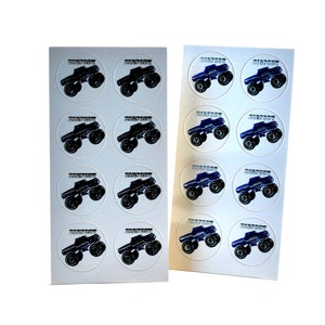 May include: Two sheets of round stickers featuring monster trucks. One sheet has black trucks, the other has blue trucks. Each sticker has the word "BIGFOOT" above the truck image.