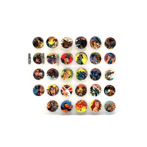 May include: A collection of vintage Batman character collectible discs. Each disc features a different character illustration in vibrant colors. The discs are arranged in a clear plastic sheet, showcasing the variety of designs.