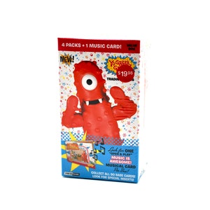May include: A red box with a cartoon character on the front. The character is a red, one-eyed monster with a toothy grin. The box says "4 packs + 1 music card!" and "Yogababa! Trading Cards".