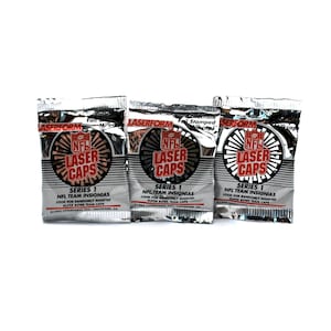 May include: Three silver foil packets with the words "NFL Laser Caps" printed on them. Each packet has a red and black logo with the words "NFL Laser Caps" and the text "Series 1 NFL Team Insignias" printed on the front.