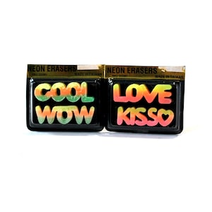 May include: Two packs of neon eraser letters. The first pack has the words "COOL WOW" in rainbow colors. The second pack has the words "LOVE KISSO" in rainbow colors.