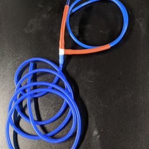 May include: Blue tubing with a red connector. The tubing is coiled and looped.