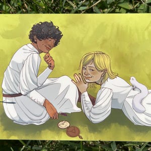 May include: A digital illustration featuring two figures with curly dark hair and blonde hair, both wearing white long-sleeved garments. A small white creature rests on the blonde figure's back. A circular brown object with a triangle symbol lies below.