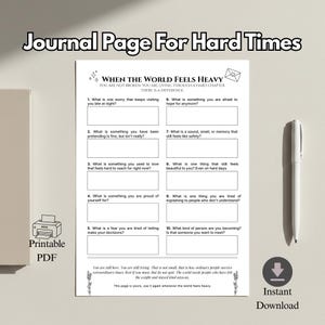 May include: A printable PDF journal page titled "Journal Page For Hard Times." The page features prompts for self-reflection, including questions about worries, fears, and things that bring joy. A pen is placed on the right side of the page.