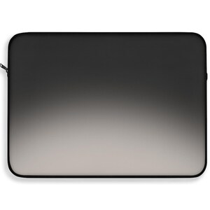 May include: A rectangular laptop sleeve featuring a smooth gradient design that transitions from a solid black at the top edge to a light gray at the bottom. The sleeve has rounded corners and a thin black zipper pull attached to the side edge.