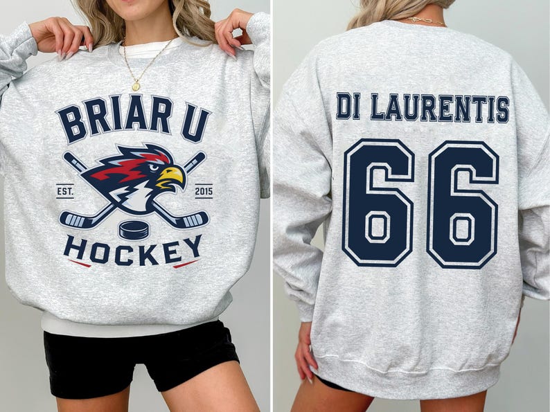 May include: A light gray crewneck sweatshirt featuring a Briar U Hockey graphic on the front with a bird mascot and hockey sticks, and the name DI LAURENTIS with the number 66 printed in large dark blue block letters on the back.