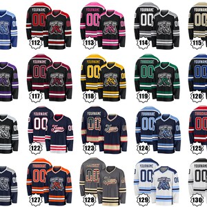 May include: Collection of hockey jerseys in various colors, each featuring a team logo and the text "YOURNAME" above the number "00". The jerseys have long sleeves and are designed for sports. The image shows multiple jersey designs.