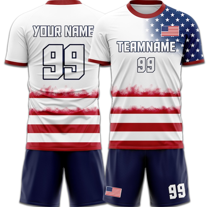 May include: White soccer jersey with red and white stripes, blue shorts. The jersey features the text "YOUR NAME" and "TEAMNAME", with the number "99". The right sleeve has a blue background with white stars and a small American flag.