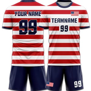 May include: A red and white striped soccer jersey and shorts set. The jersey features the text "YOUR NAME" and "TEAMNAME" with the number "99" in navy blue. The American flag is displayed on the jersey and shorts.