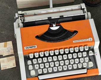 Máquina de escribir Olympia Traveller de Luxe con teclado QWERTY, 1977, color naranja, totalmente funcional