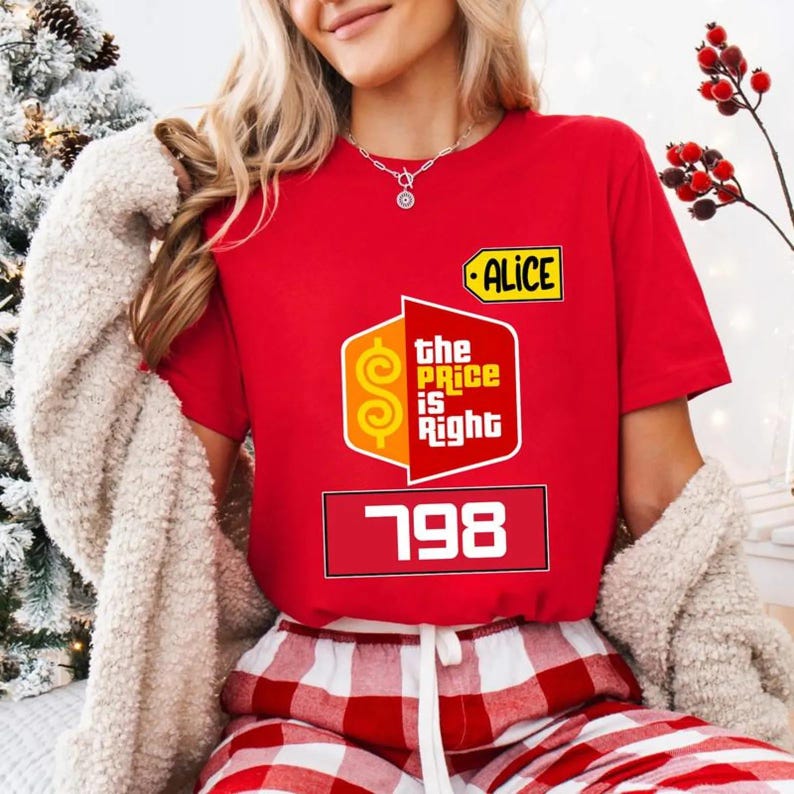 May include: A red t-shirt with the "The Price Is Right" logo, the name "ALICE", and the number "798". The person is wearing red and white checked pyjama bottoms. The shirt is a vibrant red colour.