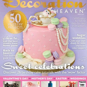 May include: The cover of "Cake Decoration Heaven" magazine features a pink cake decorated with macarons, a teacup with a bunny, and a pearl necklace. The magazine promotes 50 must-try projects and sweet celebrations.
