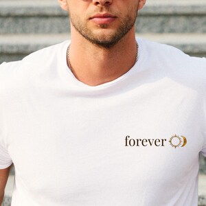 A men wearing a white shirt with a small astrology chest print with FOREVER and sun and moon. Boho whitchy minimalist gift for him.