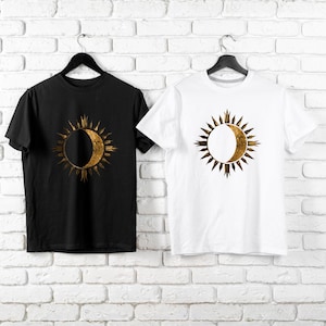 Black and white T-shirts with gold sun and moon chest print. Cosmic celestial theme. Minimalist boho astrology design gift.