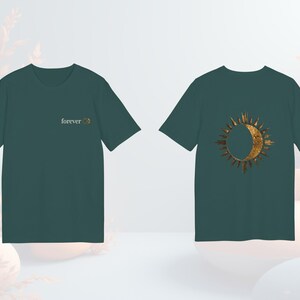 Green unisex organic cotton tee with mystical sun and moon eclipse graphic, boho witchy vibe.