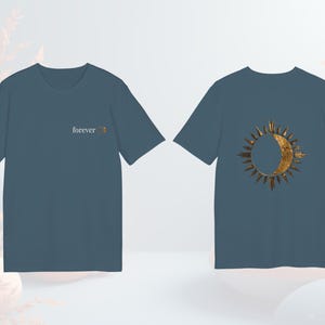 Sky blue celestial astrology tee with gold-effect sun and moon design, unisex fit.