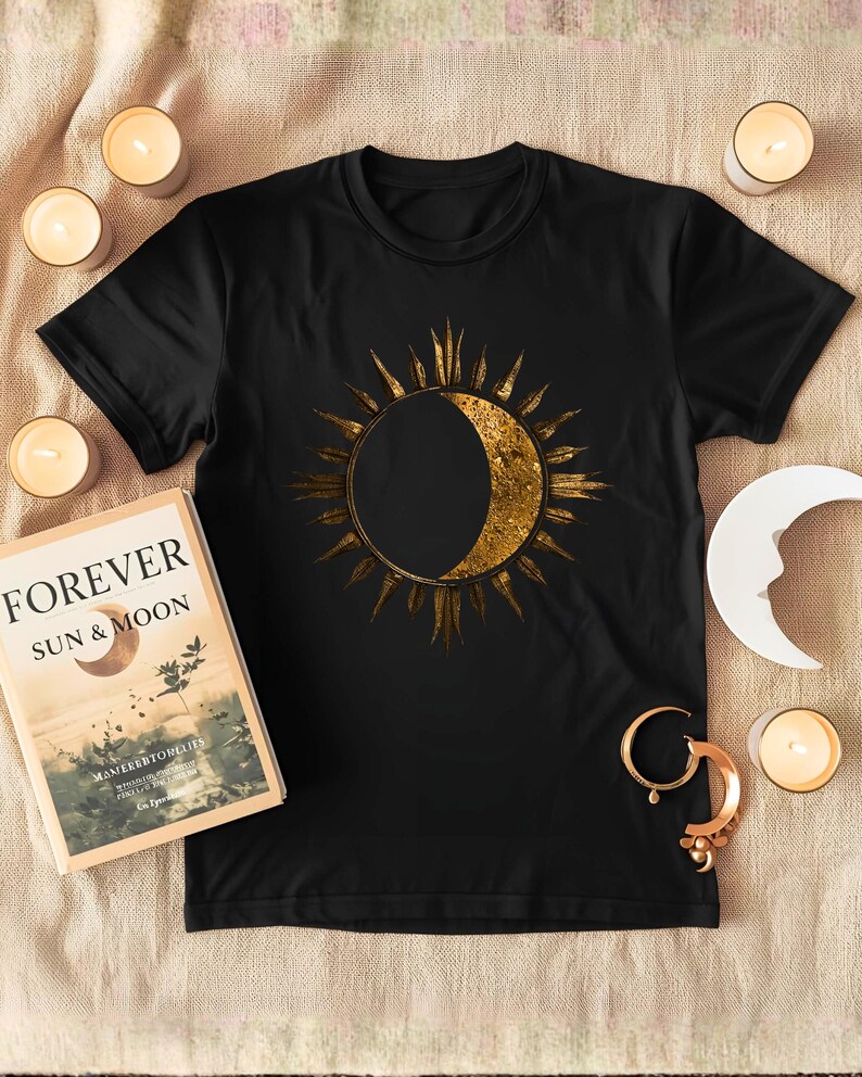 Flatlay Sun and Moon minimalist celestial print on a black organic cotton T-shirt. Detailed view of the front graphic.