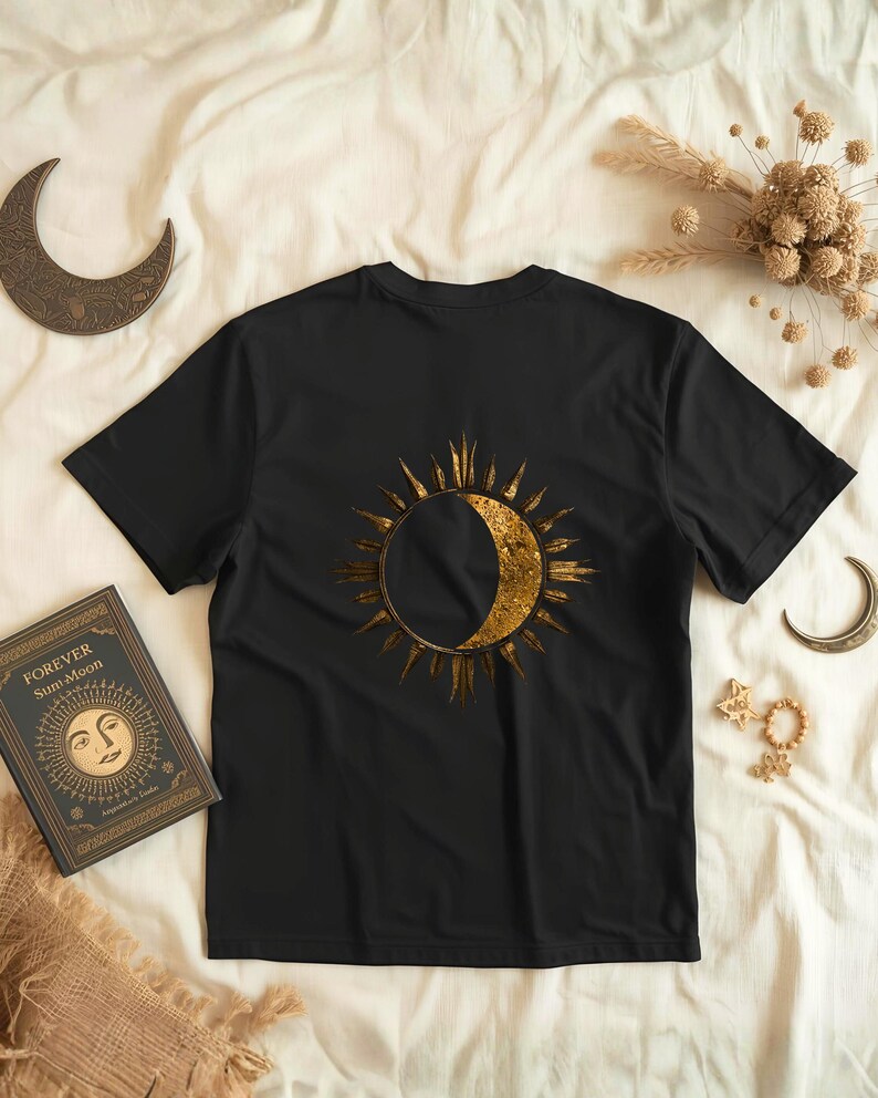 Flatlay of a black organic cotton shirt with a big astrology sun and moon statement print on the back. Celestial minimalist design.