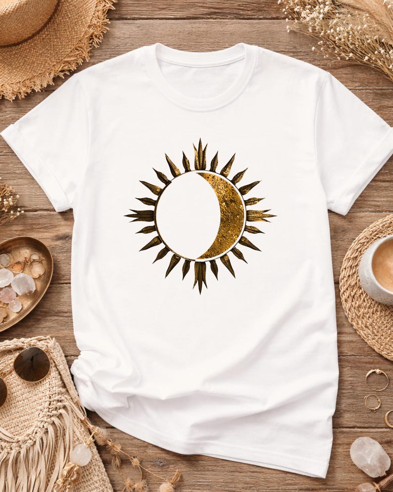 Flatlay of a white tee with Sun and Moon minimalist celestial print. Detailed view of the front astrology graphic.