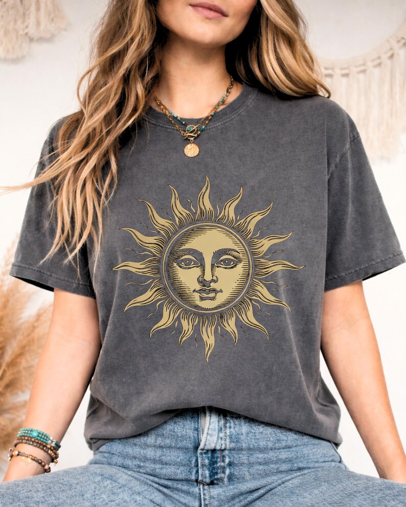 Close-up of a charcoal gray celestial sun face t-shirt featuring a vintage mystical graphic, perfect for boho fashion and astrology lovers