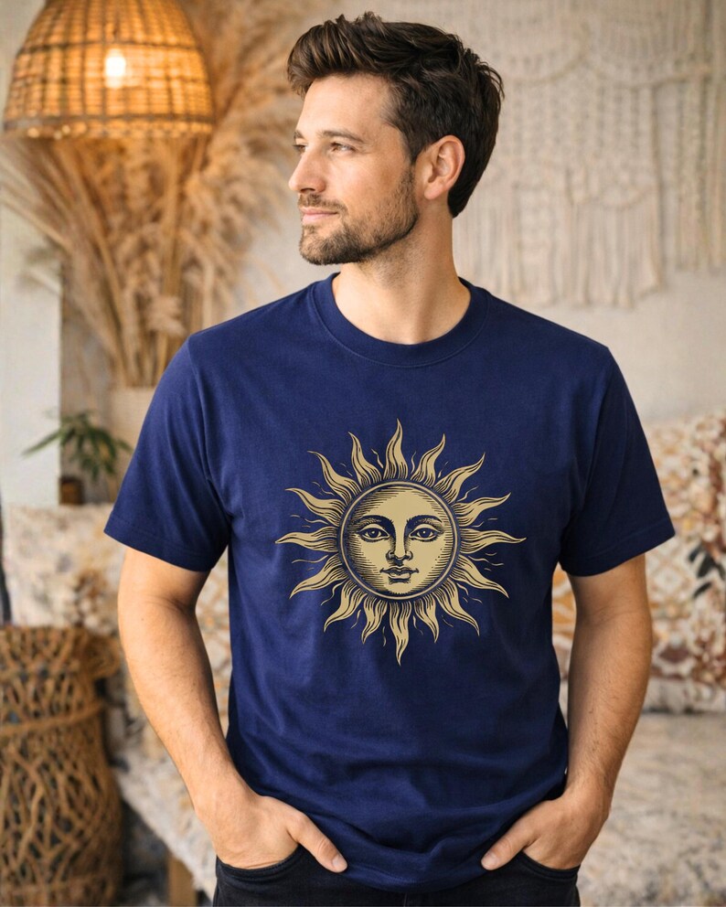 Man wearing a navy blue celestial sun graphic t-shirt with vintage boho style, a unisex astrology shirt with mystical spiritual aesthetic