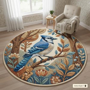 May include: A round area rug featuring a detailed illustration of a blue jay perched on a branch. The rug has a cream-colored background with a forest scene, including trees, leaves, and flowers in shades of brown, blue, and orange.