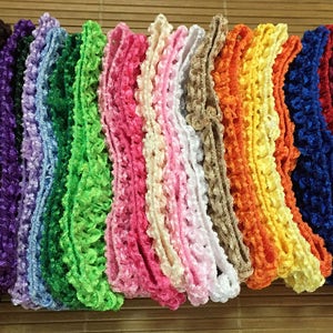 May include: Assortment of 14 different colours of ruffled trim, each trim is approximately 3.8 cm wide. The trims are made of a soft, crocheted material and are perfect for adding a touch of elegance to any project.