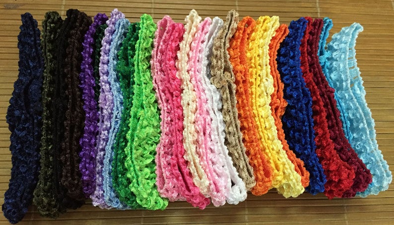 May include: Assortment of 14 different colours of ruffled trim, each trim is approximately 3.8 cm wide. The trims are made of a soft, crocheted material and are perfect for adding a touch of elegance to any project.