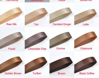 May include: A collection of 20 different colored satin ribbon samples. The colors are arranged in four rows of five samples each. The colors include Carmandy, Candlelight, Taupe, Buttermilk, Raw Silk, Tan, Candied Ginger, Latte, Fossil, Chocolate Chip, Ermine, Chipmunk, Golden Brown, Turftan, Brown, Black Coffee, Licorice, Cappuccino, Root Beer, and Friar Brown.