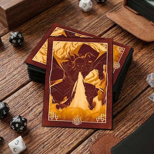 Puede incluir: Un montón de fundas marrones para cartas con una ilustración ardiente de un personaje. La obra de arte presenta una figura con llamas y un símbolo de fuego. Dados y un estuche de cuero son visibles sobre una superficie de madera.
