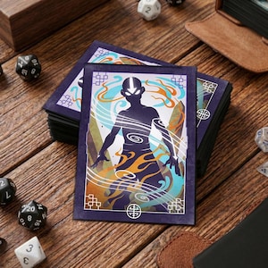 Puede incluir: Una pila de protectores de cartas con borde púrpura que presenta la silueta de un personaje con la cabeza rapada y marcas en forma de flecha. El diseño incluye elementos arremolinados en naranja, azul y blanco. Dados y una caja de madera en el fondo.