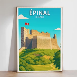 May include: A framed travel poster featuring the Épinal castle in France. The poster has a blue sky with white clouds, a stone castle on a green hill, and the text "ÉPINAL LE CHÂTEAU" at the top.