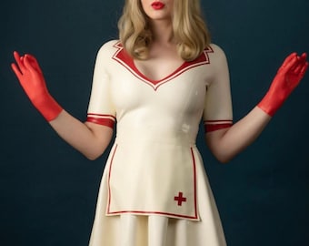 May include: A white latex nurse dress featuring short sleeves, a V-neckline with red trim, and a matching apron with a red cross emblem. The outfit includes a white nurse cap with a red cross and a pair of vibrant red latex gloves.