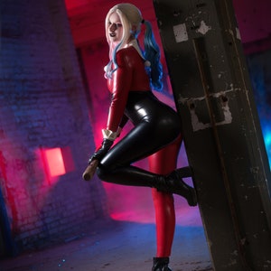 Transform into the iconic and mischievous Harley Quinn with our custom cosplay catsuit!

This catsuit features a vibrant red and black colour scheme, just like the original outfit.