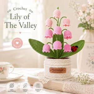 May include: A handmade crochet Lily of the Valley plant in a white crocheted pot. The pink flowers and green leaves are detailed, with a small ladybug accent. The pot has a Florentale label.