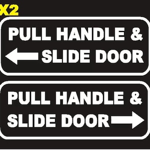 May include: Two black rectangular signs with white text reading "PULL HANDLE & SLIDE DOOR". One sign has a left-pointing arrow, the other a right-pointing arrow. The text "X2" is in yellow in the upper left corner.