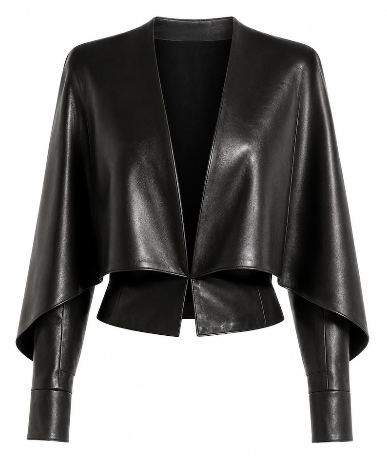 A black leather cropped jacket with draped short sleeves and fitted lower sleeves displayed against a plain background.