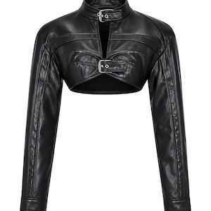 May include: A black long-sleeve cropped jacket featuring a high collar with a silver buckle closure and a second silver buckle across the chest. The garment has a smooth finish, long sleeves with cuffs, and a cut-out design at the midsection.