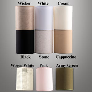 May include: A collection of cylindrical lampshades in various colors and textures. The shades include options like black, white, cream, pink, and army green. Some shades have a woven or textured appearance, while others are smooth. The labels on the image indicate the color names.