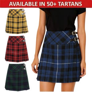 May include: A selection of tartan skirts in various colors, including yellow, red, green, and blue. Each skirt features a pleated design and buckle closures. The image includes the text "AVAILABLE IN 50+ TARTANS".