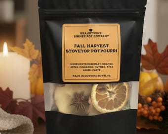 May include: A black pouch with a clear window displaying dried orange slices, star anise, and apple slices. The label reads "Fall Harvest Stovetop Potpourri" with a list of ingredients. The package is from Brandywine Simmer Pot Company.