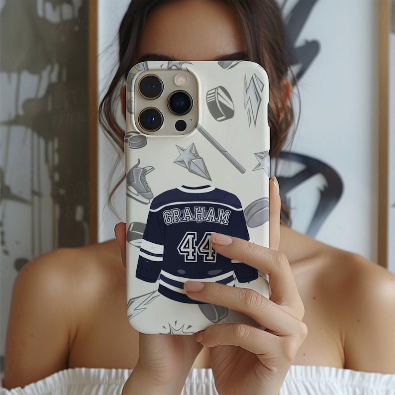 Off Campus phone case cream iPhone Pro gold trim Graham 44 navy jersey hockey icons, mirror selfie brunette model